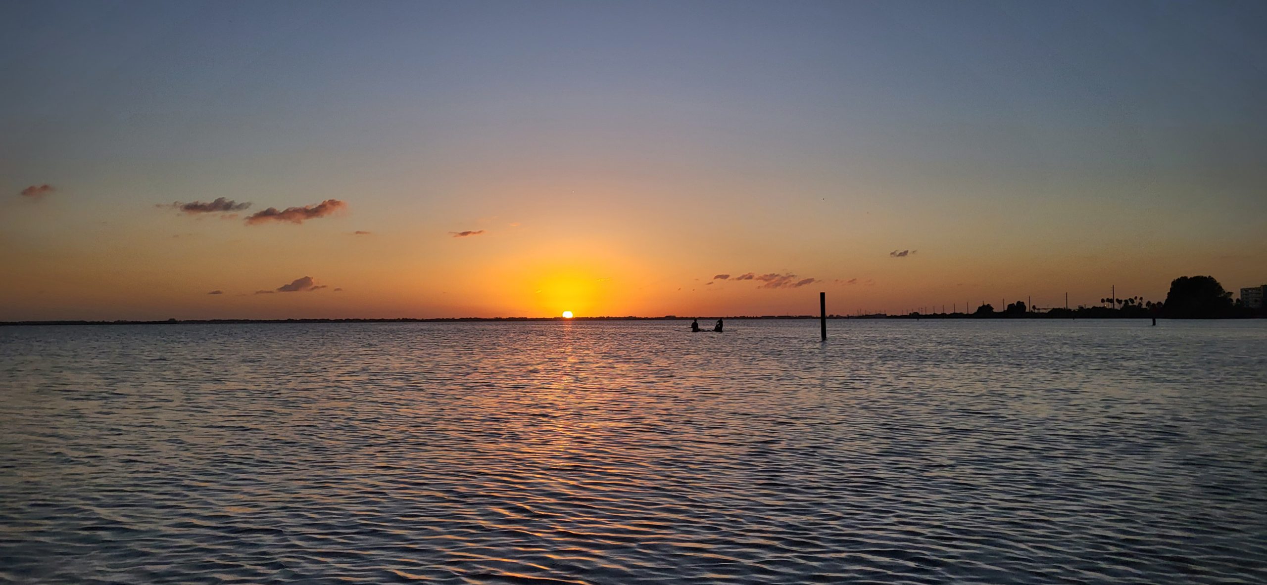 Sun setting over calm water on the Space Coast